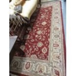 Machine woven Persian design carpet with medallion and floral design on a red ground,