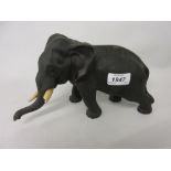 Late 19th Century Japanese dark patinated bronze figure of an elephant with ivory tusks (one a/f),