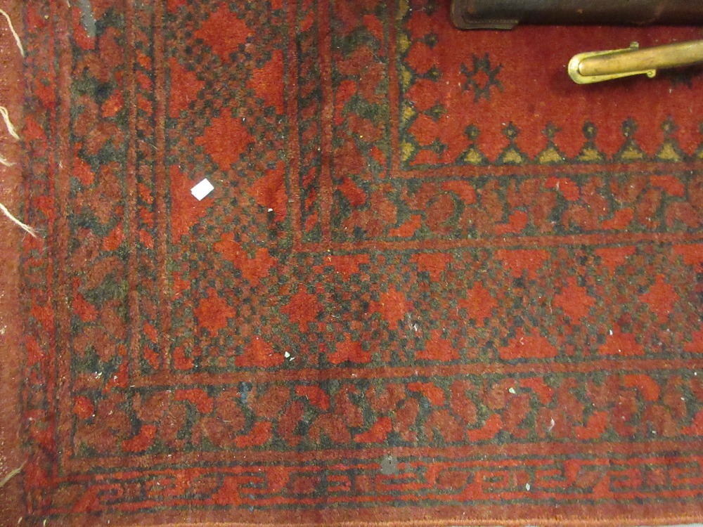 Small Afghan rug with triple gol design on a red ground,