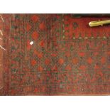 Small Afghan rug with triple gol design on a red ground,