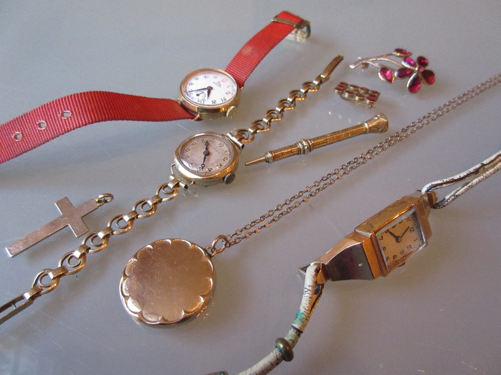 Three various ladies 9ct gold wristwatches, 9ct gold photograph locket, two brooches,