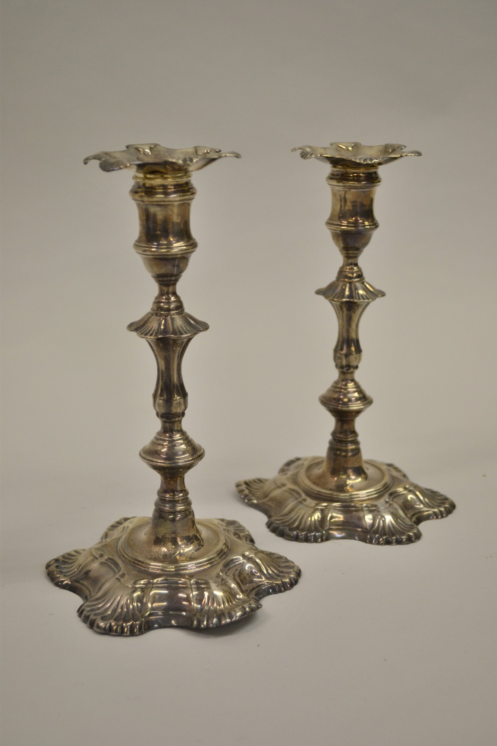 Pair George II cast silver baluster form candlesticks with engraved family crest, London 1751,