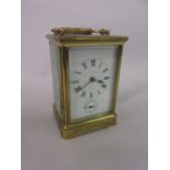Early 20th Century brass cased carriage clock with enamel dial and Roman numerals,