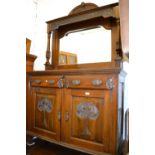 Art Nouveau walnut sideboard with a mirrored back above two drawers,