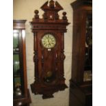 Large early 20th Century walnut Vienna style wall clock having turned and carved broken arch