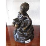 20th Century bronzed resin figure of a seated boy with a book together with an African carved