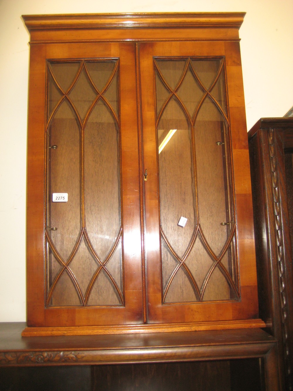 Reproduction yew wood two door wall cabinet with bar glazed door