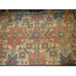 Kazak style rug with twin medallion design in shades of rose, blue and ivory,