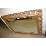 Rectangular gilt framed overmantel mirror having carved scrolled and pierced border,