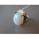 18ct White gold oval opal and diamond ring, the opal approximately 6.