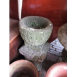 Pair of circular stone garden urns on stepped platform bases