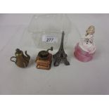 Four various tape measures in the form of crinoline lady, Eiffel Tower,