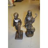 20th Century dark patinated bronze figure of a Dutch boy together with a figure of a girl carrying