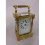 20th Century gilt brass cased carriage clock having enamel dial with Roman numerals and two train