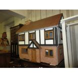 Large modern dolls house with beamed and brick facade on stand