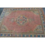 Turkey carpet with a lobed medallion and all-over floral design on a salmon pink ground with