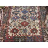 Caucasian Kelim rug with an all-over stylised design and multiple borders on an ivory ground,