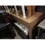 Contemporary ash consul table with three frieze drawers raised on square supports