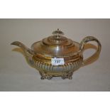 George IV silver oval teapot with gadroon decoration, chased scroll handle raised on shell,