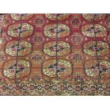 Small Tekke rug with three rows of six gols on a wine ground with borders,