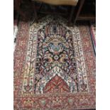 Indo Persian prayer rug with a vase design on a blue ground with borders,