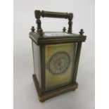 Small French brass cased carriage clock with circular dial,