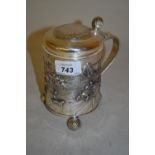 Danish white metal tankard with a floral engraved hinged lid and thumb piece above a shaped handle,