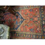 Kurdish rug with single lobed medallion and all-over design on a red ground with borders,