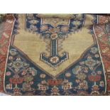 Hamadan rug with centre medallion and multiple borders on a beige ground,