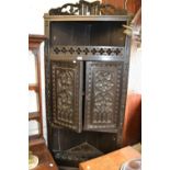 19th Century carved dark oak standing corner cabinet on cabriole claw and ball supports
