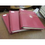 Three red albums containing a quantity of various Australian,