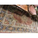 Machine woven Persian design rug with a medallion and all-over floral design on a pink ground with