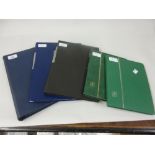 Four stock books and a folder containing a collection of U.S.A.