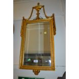 Reproduction gilt framed wall mirror with urn and swag surmount together with another similar