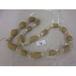 Large vertebrae and carved bone necklace,