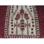 Belouch prayer rug with a stylised design on an ivory ground with multiple red ground borders