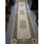 Two Chinese rugs with medallion and plain designs on a beige ground