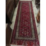 Pakistan Kurdish design runner with central medallions and multiple borders on a burgundy ground,