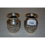 Pair of late 19th / early 20th Century silver squat baluster form vases decorated in high relief