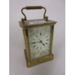 Small early 20th Century brass cased carriage clock, the enamel dial with Roman numerals,