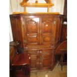 Reproduction oak corner cocktail cabinet, the moulded cornice above a pair of arched panel doors,