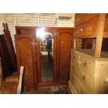 Victorian mahogany wardrobe with a moulded cornice above three doors enclosing hanging space,