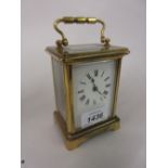 Small brass cased carriage clock with enamel dial,