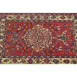 Baktiari rug with a lobed centre medallion and all-over stylised floral design on a red ground with