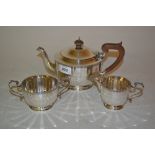 Three piece silver tea service of circular faceted baluster form,