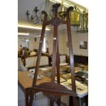Edwardian carved mahogany picture easel with shaped surmount