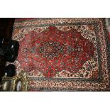 Small Tabriz rug with a lobed medallion and all-over floral design on a pink ground with borders,