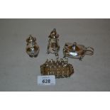 Miniature Birmingham silver toast rack and three silver condiments