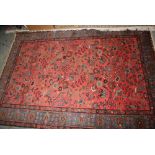 Near matching Saruq rug with all-over stylised floral and bird design on a pink ground with blue