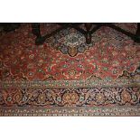 Modern Kashan carpet with a lobed medallion and all-over floral design on a pink ground with